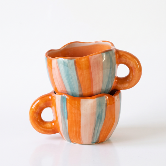 two stacked orange and blue mug
