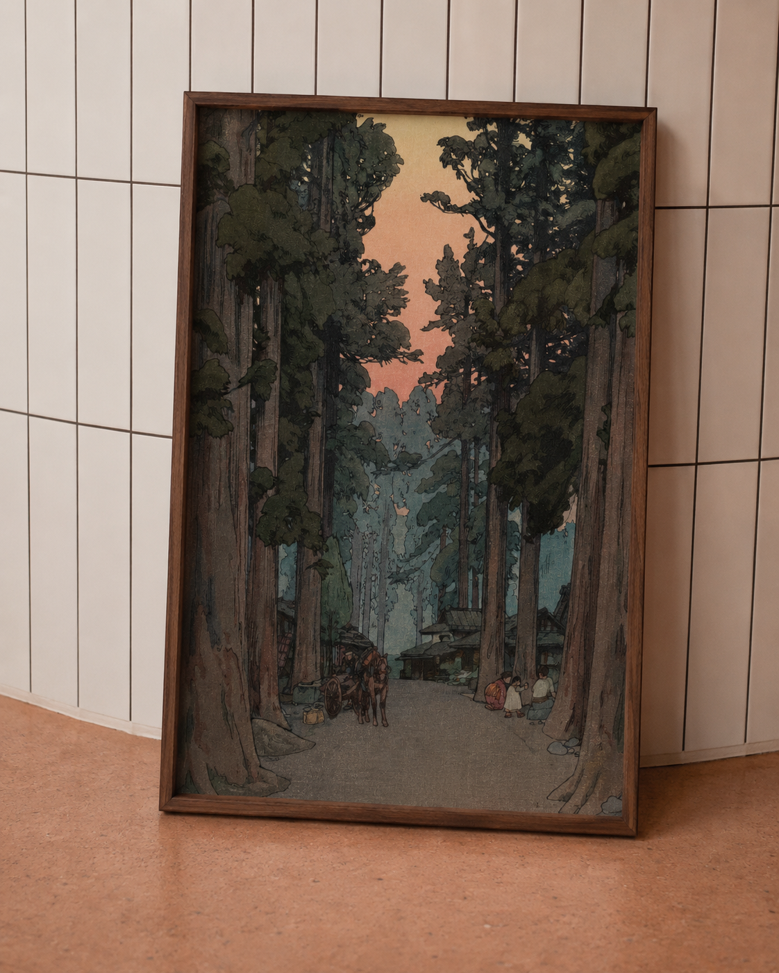 Framed artwork of a forest scene on a tiled wall.