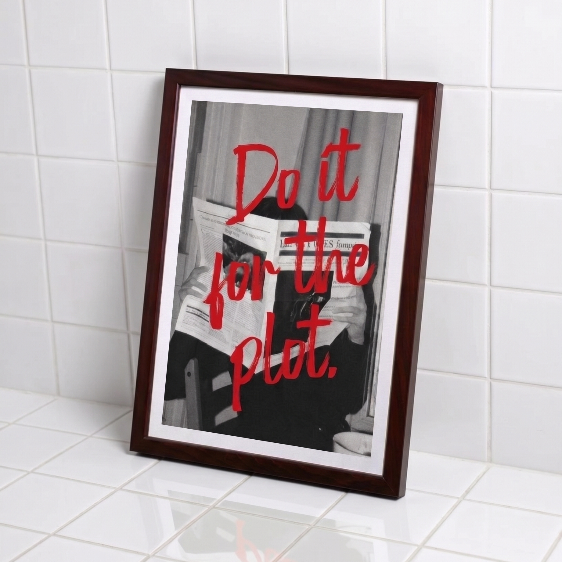 Framed print with 'Do it for the plot' text on a tiled wall.