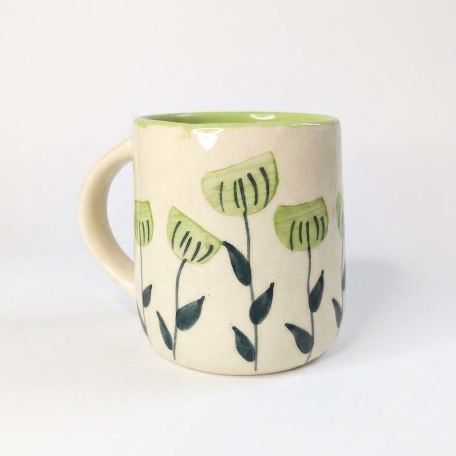 Green floral coffee mug on a white background