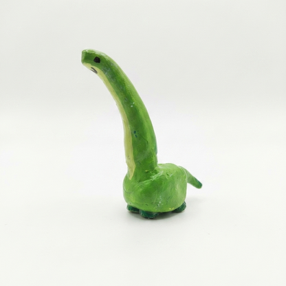 Green dinosaur ring on a white background