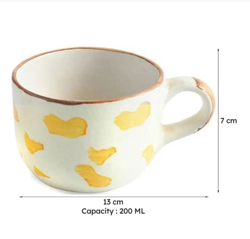 Ceramic mug with yellow heart patterns and dimensions on a white background