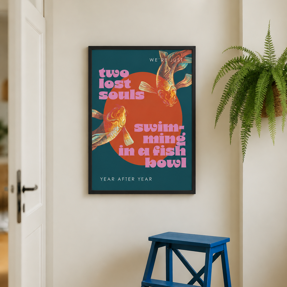 A framed poster with retro-style text and koi fish artwork hangs on a beige wall in a real interior setting, with a blue step stool below and a green plant to the right.