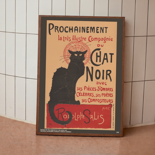 Framed poster of a black cat with text on a tiled wall background
