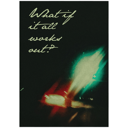 poster design on a white wall - the text reads what if it all works out with blurry traffic lights in the background
