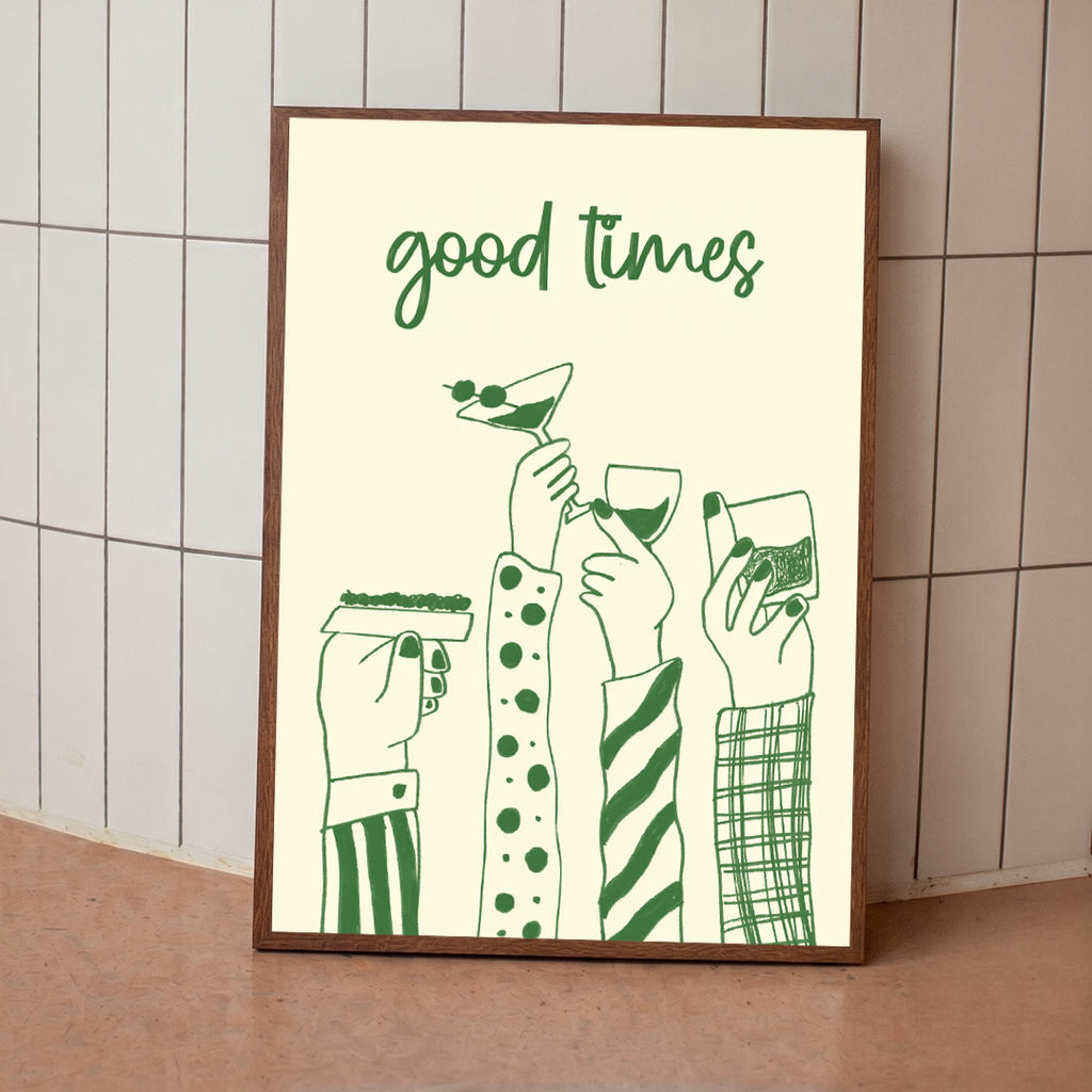 Framed artwork with 'good times' text and green illustrations of hands holding drinks against a tiled wall.