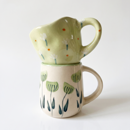 stacked green mug on white background